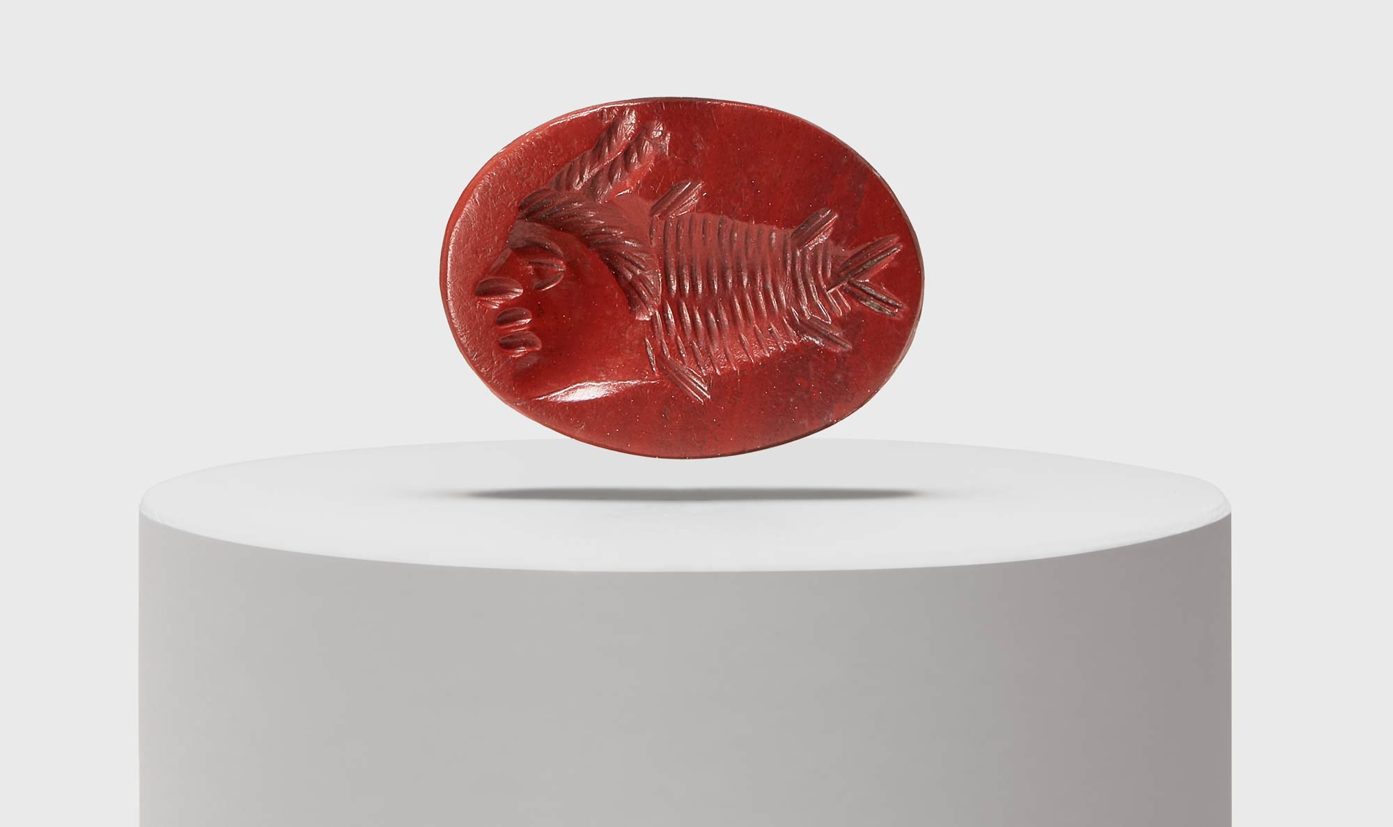 Roman art, Gem with gryllos composed of fish and human face (2nd century AD; red jasper; Aquileia, National Museum). Photo by Slowphoto, MAN Aquileia archives.