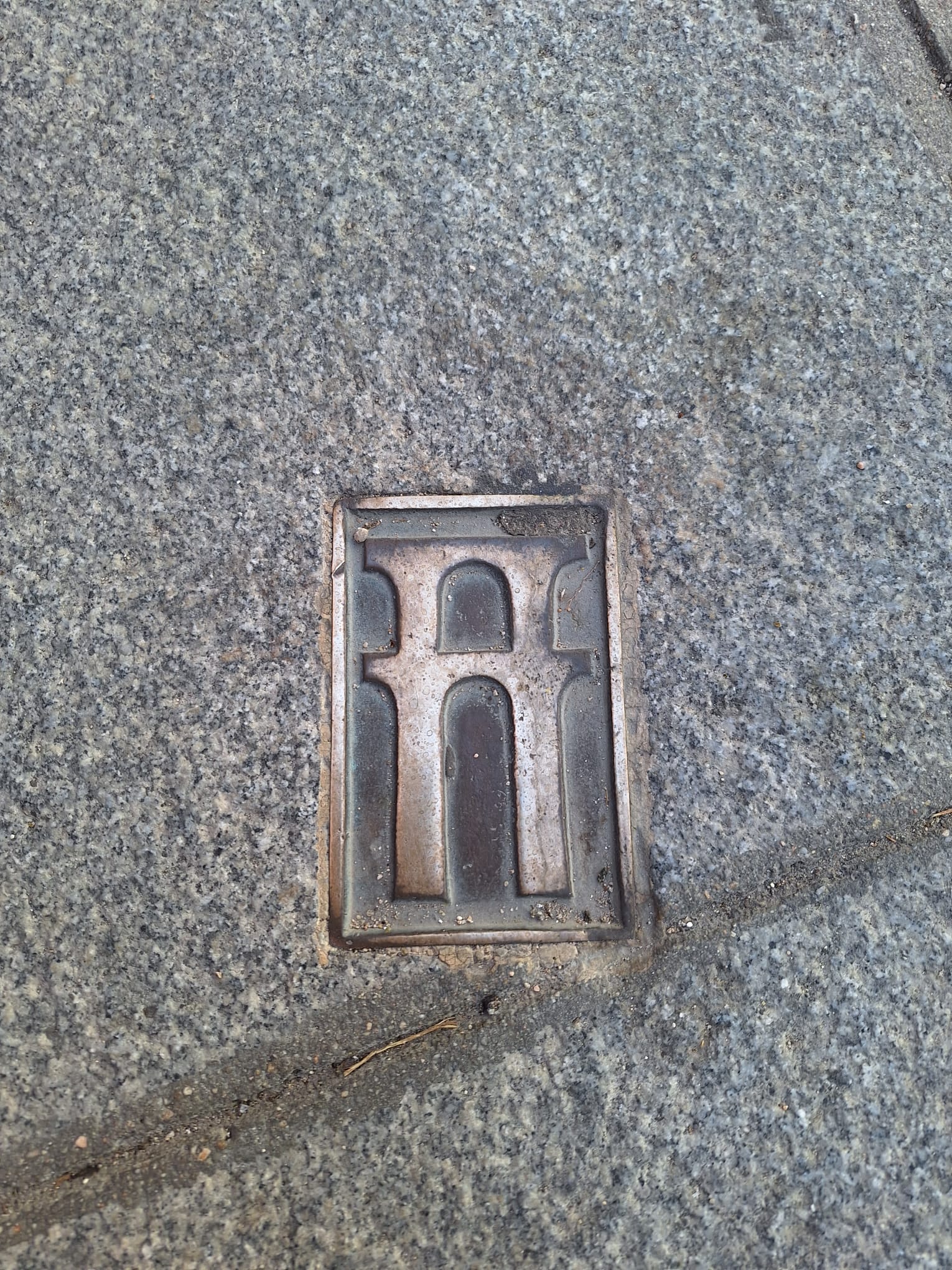 Segovia, a symbol on the ground indicating the route of the aqueduct. Photo: Finestre Sull'Arte