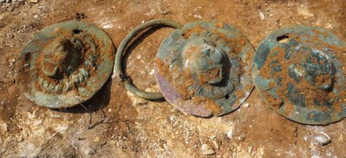 Three of the lion's head discs recovered from Tomb T6. Photo: A. Peretz.