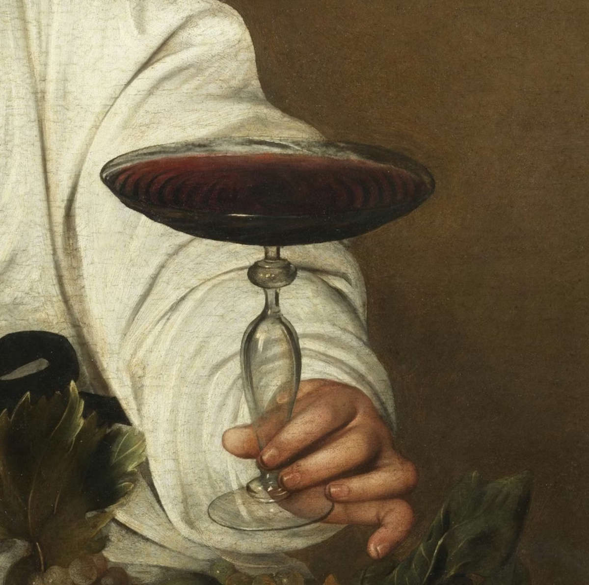 The glass of wine and the hand