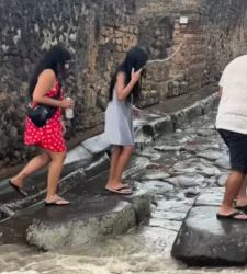 A violent storm hits Pompeii, and visitors use the ancient crosswalks